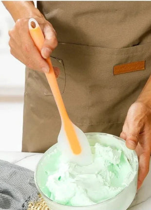 A green silicone spatula, safe for food use and great for various kitchen tasks.