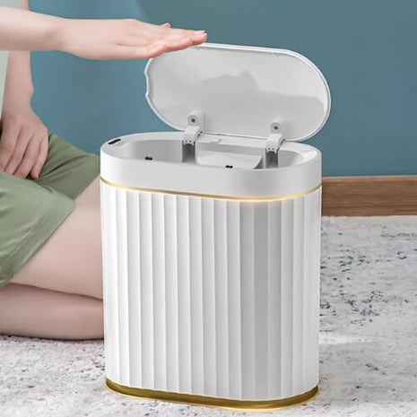 A stylish trash can with a blend of white and subtle gold accents. Perfect for modern spaces.